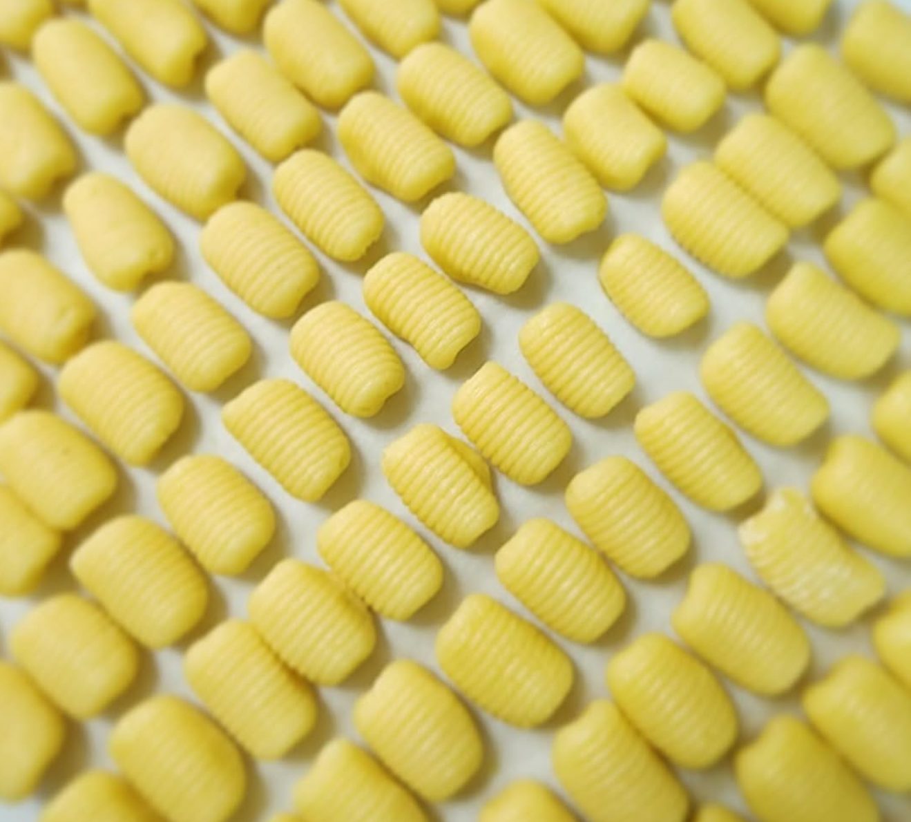 Homemade gnocchi lined up before cooking
