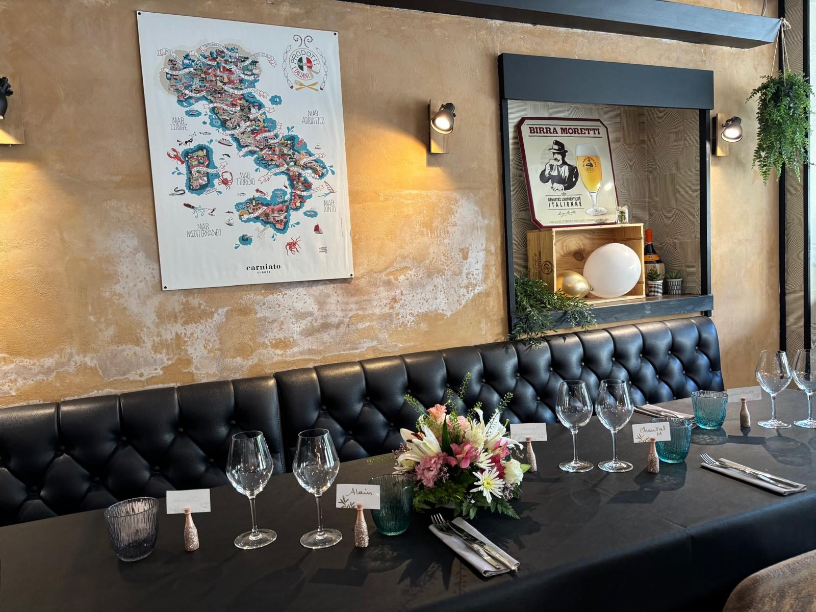 The dining room at L'Atelier Montois, banquette and map of Italy