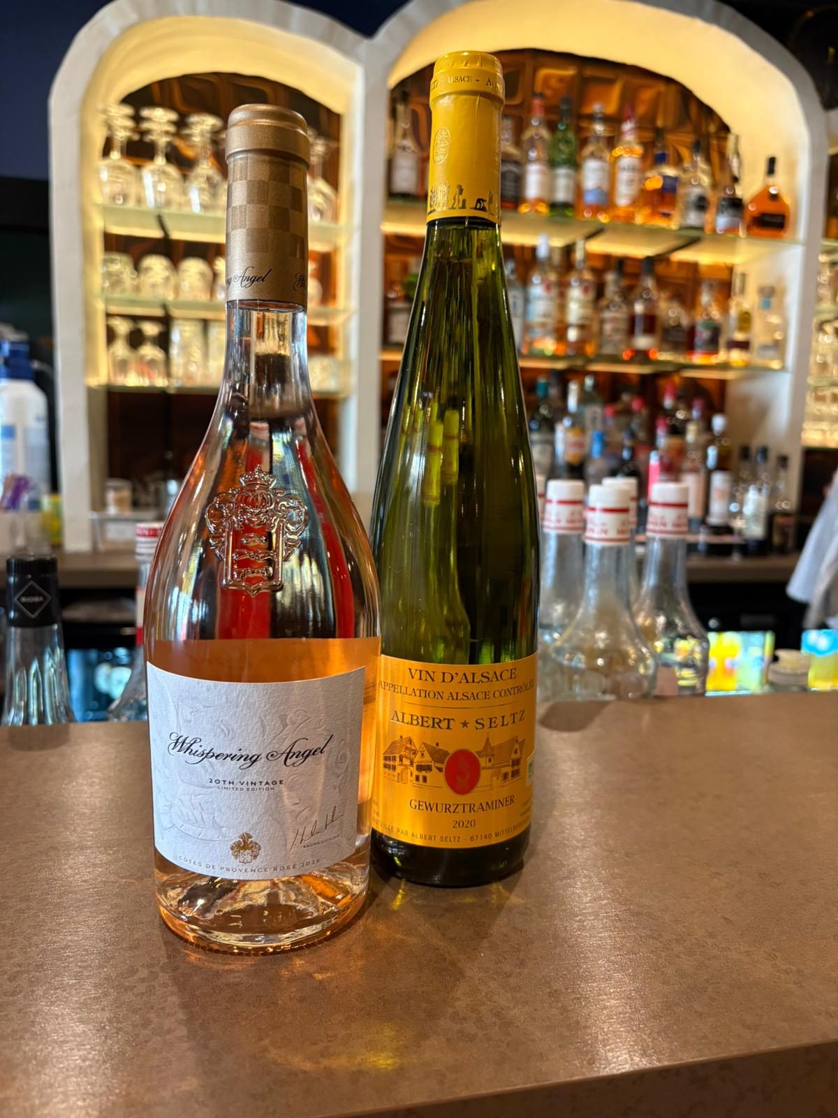 Two bottles on the bar counter, in front of the arches